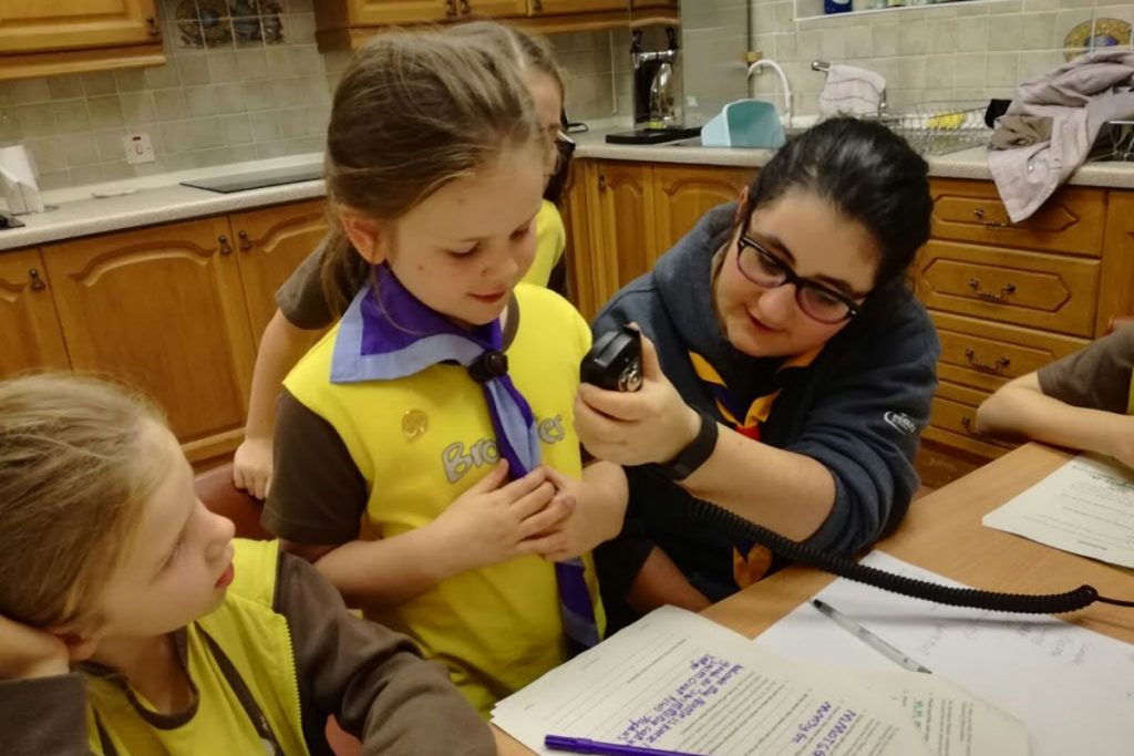 Brownies learning to use a radio communicator