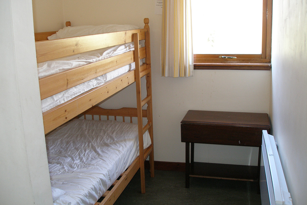 Dorm room with one bunk bed